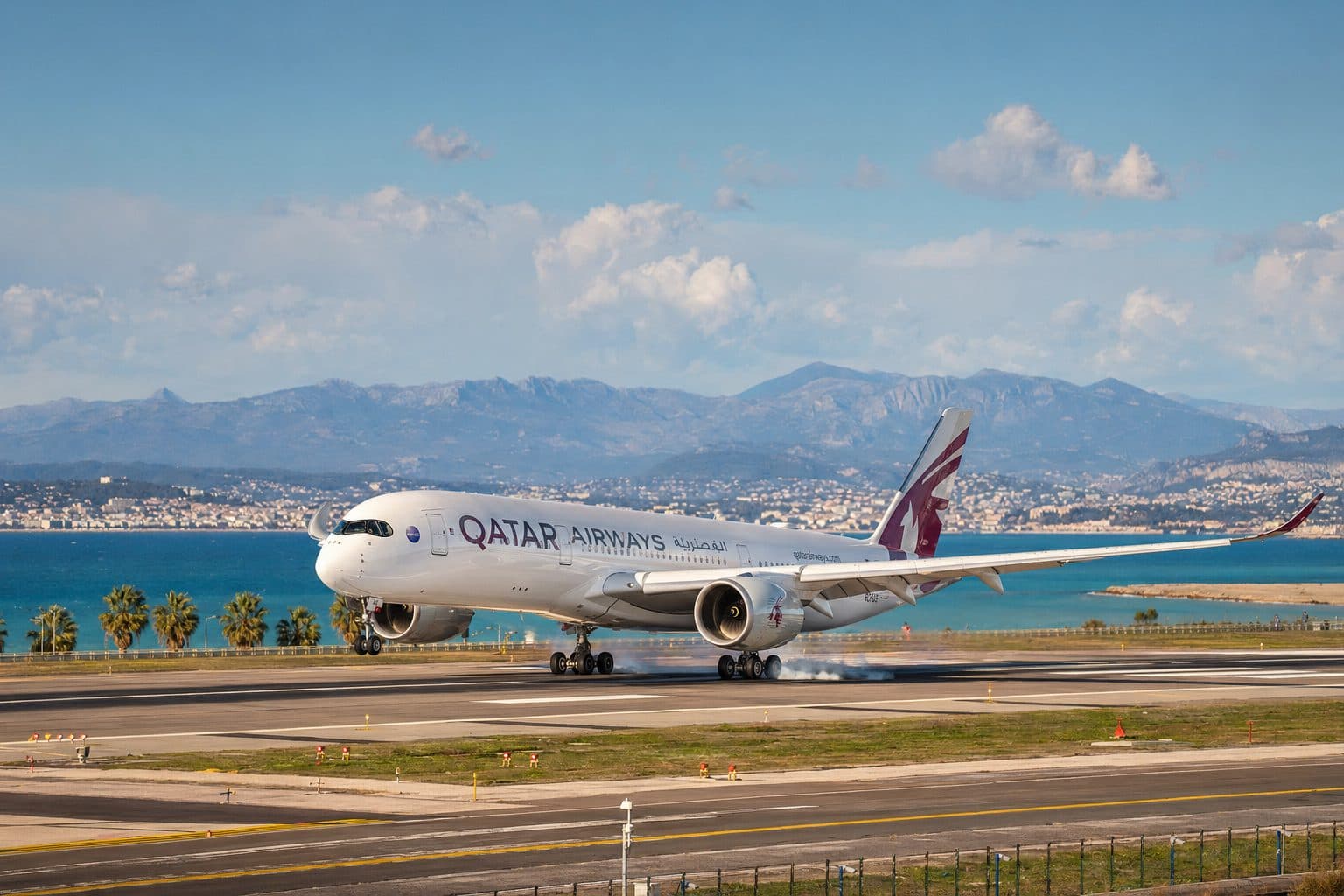 A Qatar Airways aircraft in the airline's burgundy and grey livery