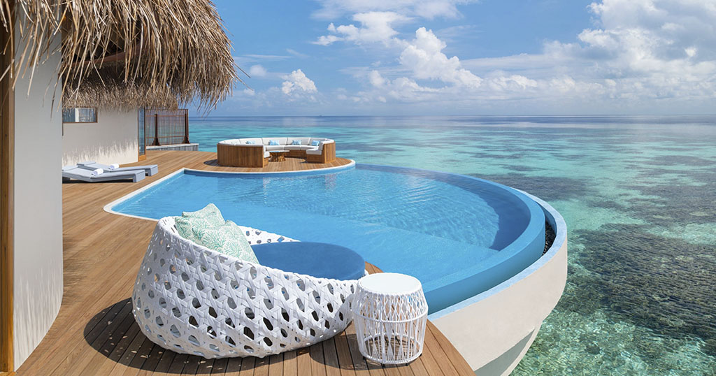 A luxurious oceanfront deck with an infinity pool and lounge seating