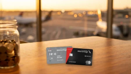 Citi AAdvantage Platinum Select and AAdvantage Aviator Red cards on an airport lounge table at sunset