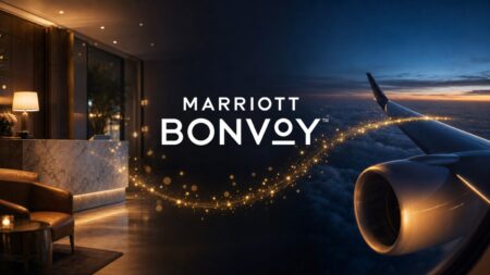 Marriott Bonvoy logo over a hotel lobby and an airplane wing, with a stream of golden points flowing between them